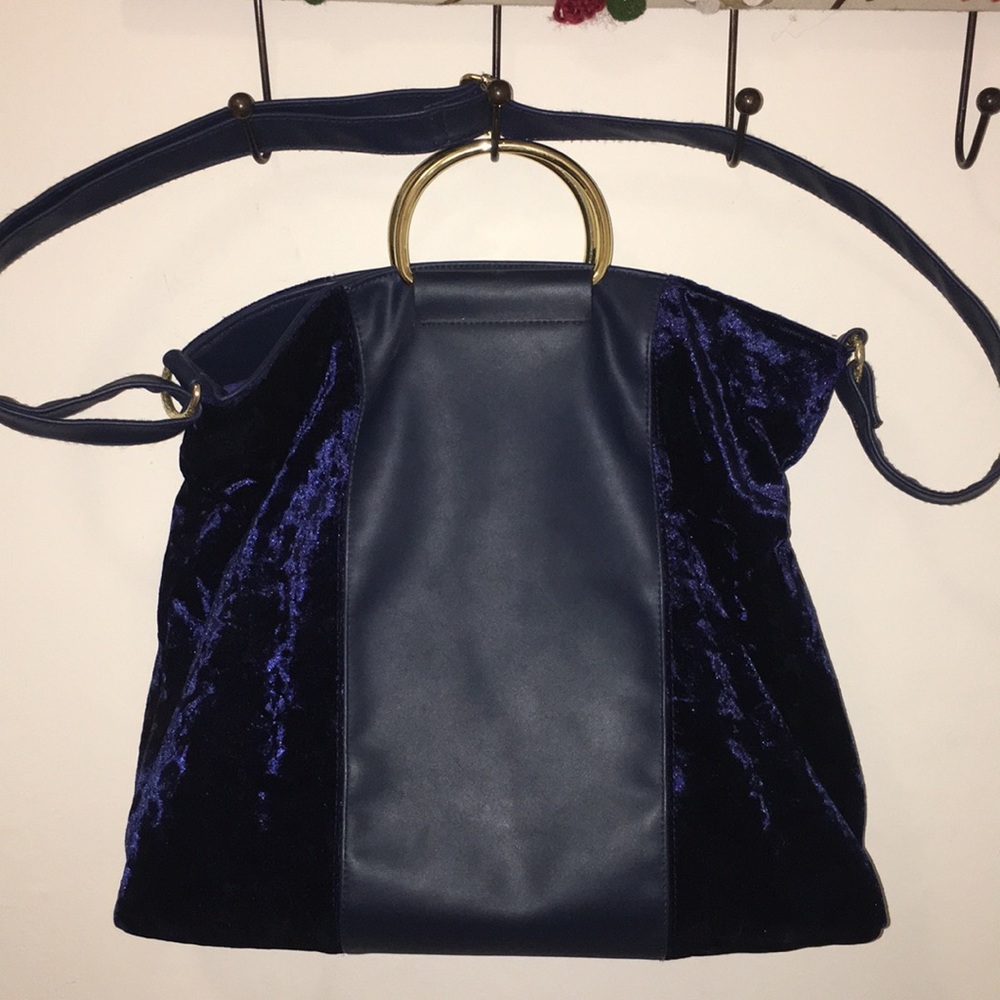 Francesca’s blue velvet handbag with gold hardware